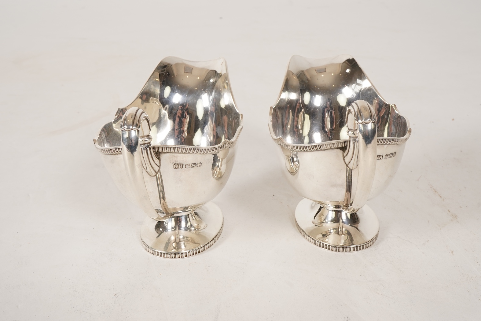A pair of George V silver pedestal sauce boats, by Howson Brothers